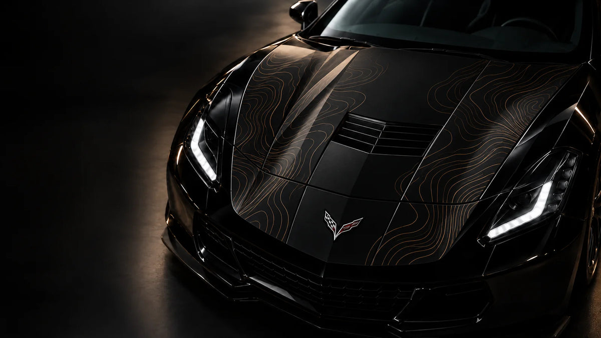 Bronze contour car wrap on the hood of a black sports car