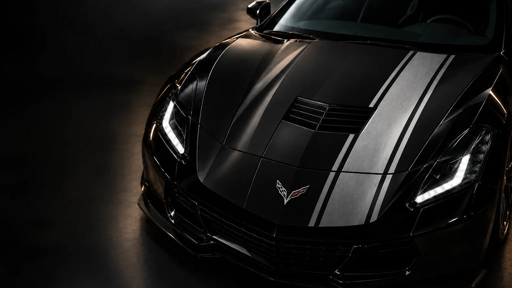 Silver apex car wrap on the hood of a black sports car