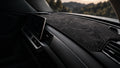 Graphite contour dashboard mat fitted in a car's cabin
