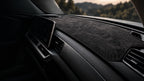 Graphite contour dashboard mat fitted in a car's cabin