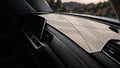 Ivory geometric dashboard mat fitted in a car's cabin